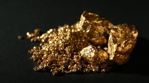 An image of a large gold nugget, across a black background 