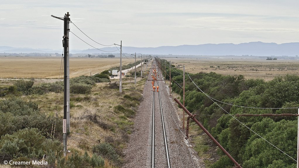 An image of rail workers on a Transnet line
