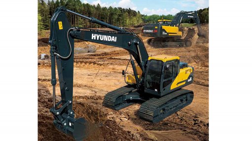Black and yellow Hyundai crawler excavator machine excavating earth