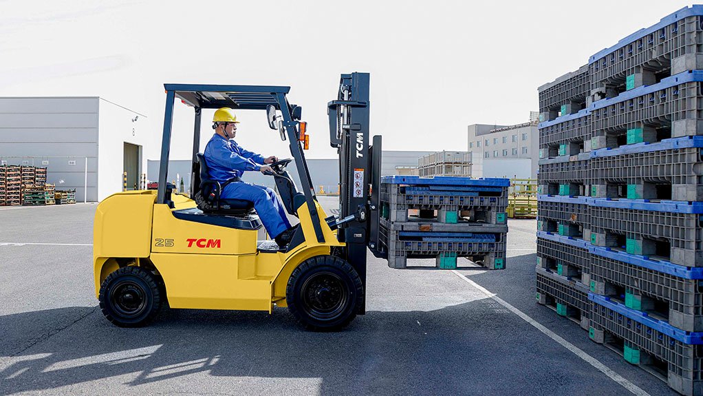 Man operating a yellow and black TCM T5C forklift truck
