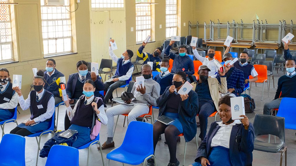 A photo of learners holding up their new e-learning devices from Odin Education
