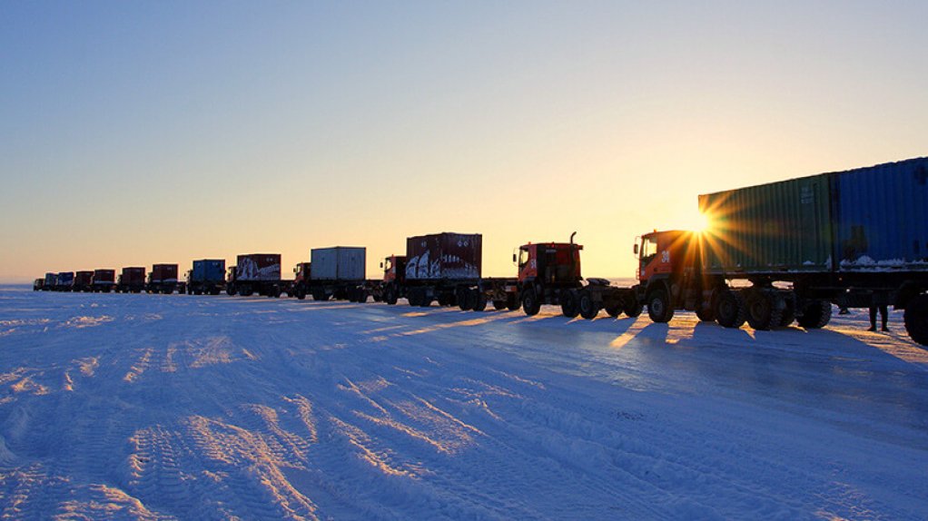 An image of trucks lining up on a winter ice road