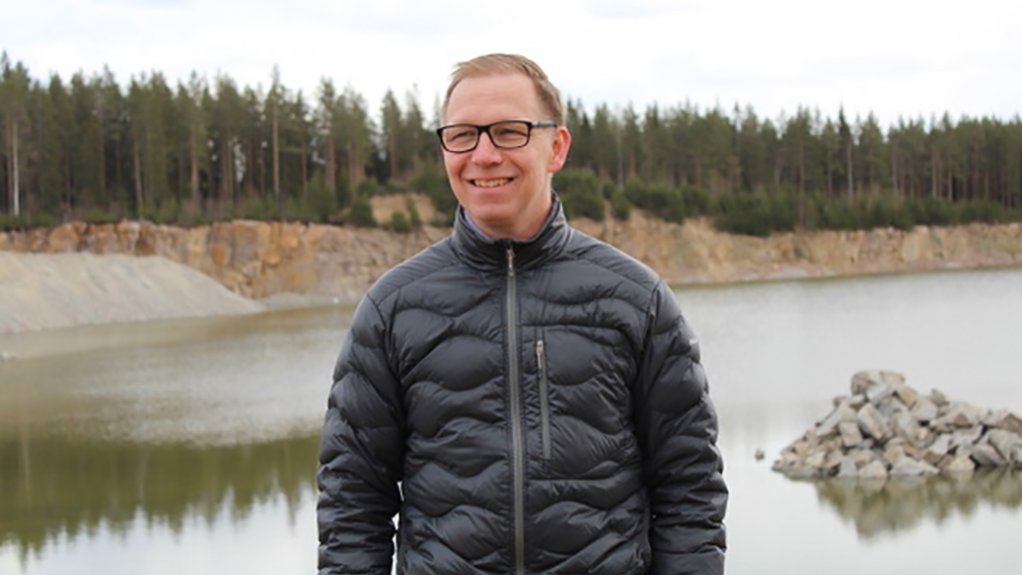 A photo of Mine Storage CEO Thomas Johansson stood in front of a lake and wooded area