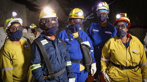 An image of five women miners standing underground at the Royal Bafokeng Platinum North shaft