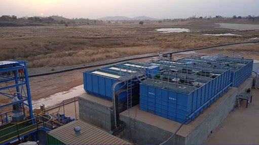 A wastewater treatment plant for a gold mine in Mali, with large blue water tanks and pipe reticulation for the gold mine that uses the water