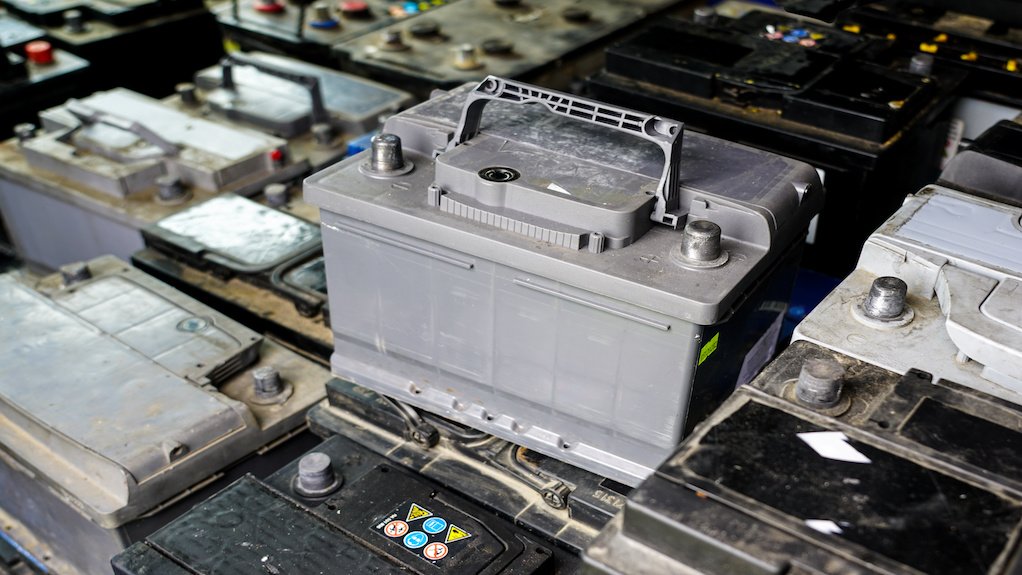 Pallet with many used car batteries for recycling