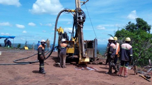 Men standing around a core drilling machine which is taking geotechnical samples to be evaluated elsewhere, at the Mahenge Liandu project in Tanzania