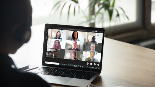 A stock image of a person using a tablet to participate in a video call/meeting 