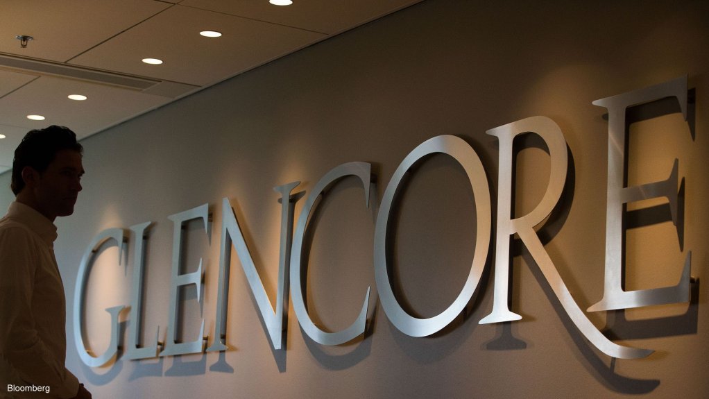 An image of a man standing with the logo of Glencore 