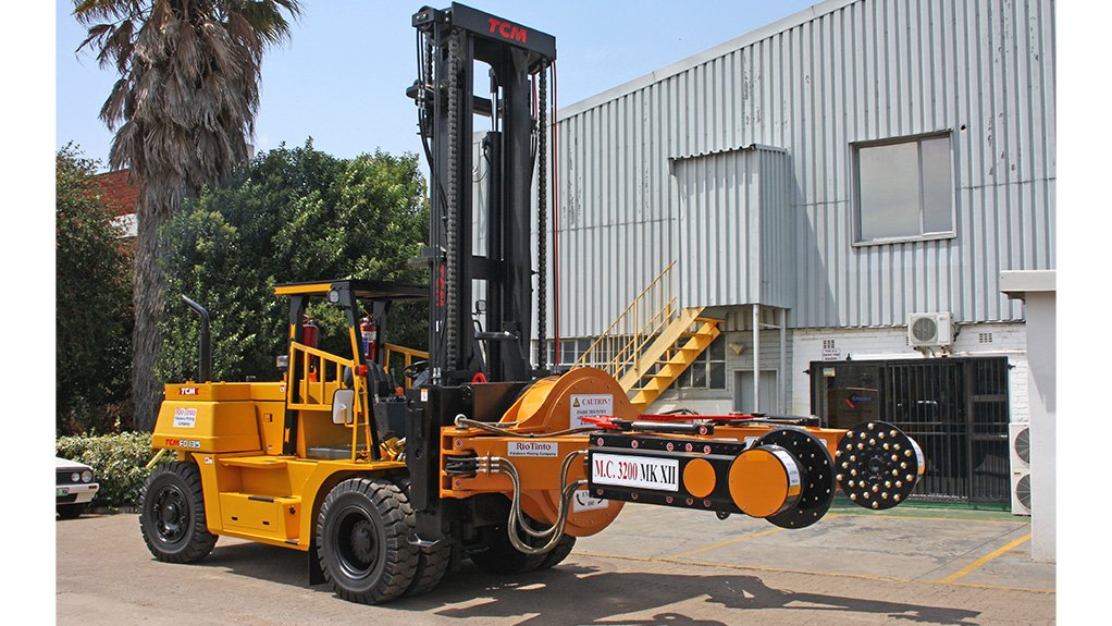 A yellow Criterion ATCM forklift truck with wheel handling attachments which is used to lift heavy loads