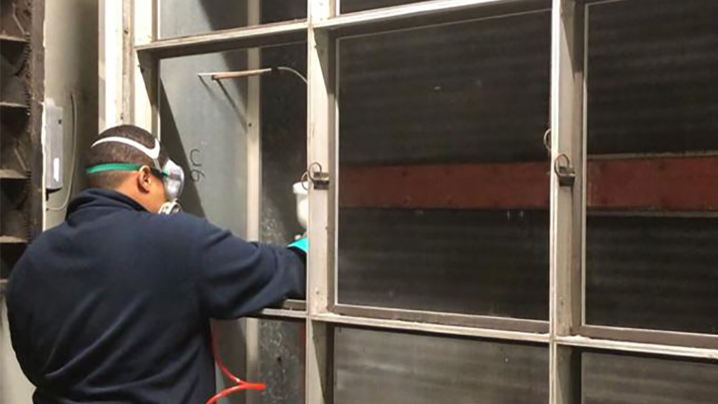 Image of a worker cleaning an AHU