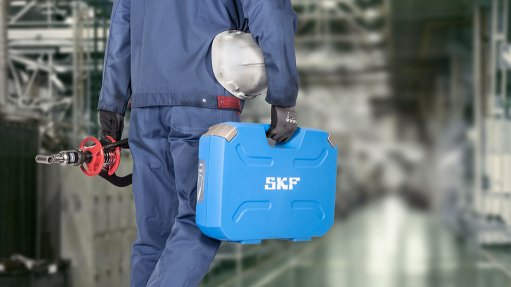 Photograph of worker carrying a tool box, to show that SKF provides free issue-specific maintenance advice