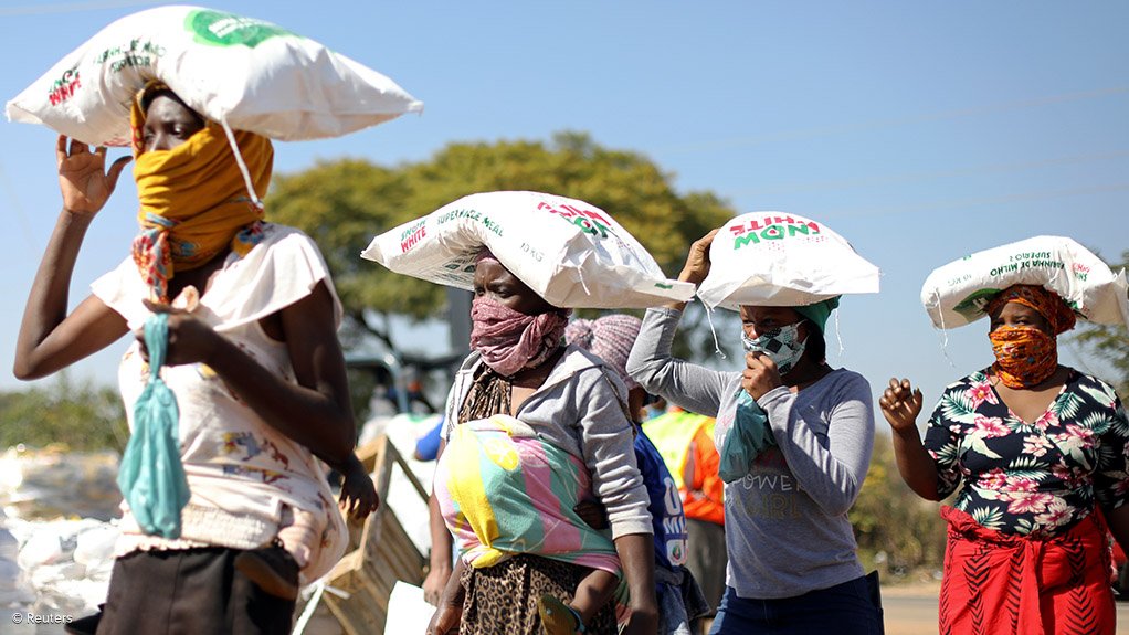 Women carrying maize meal