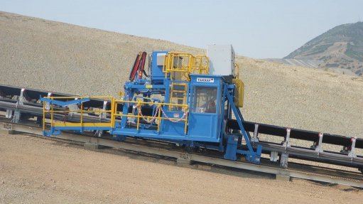 An image depicting the blue and yellow TAKRAF maintenance cart on a steep 26% decline section at a copper mine, in the US