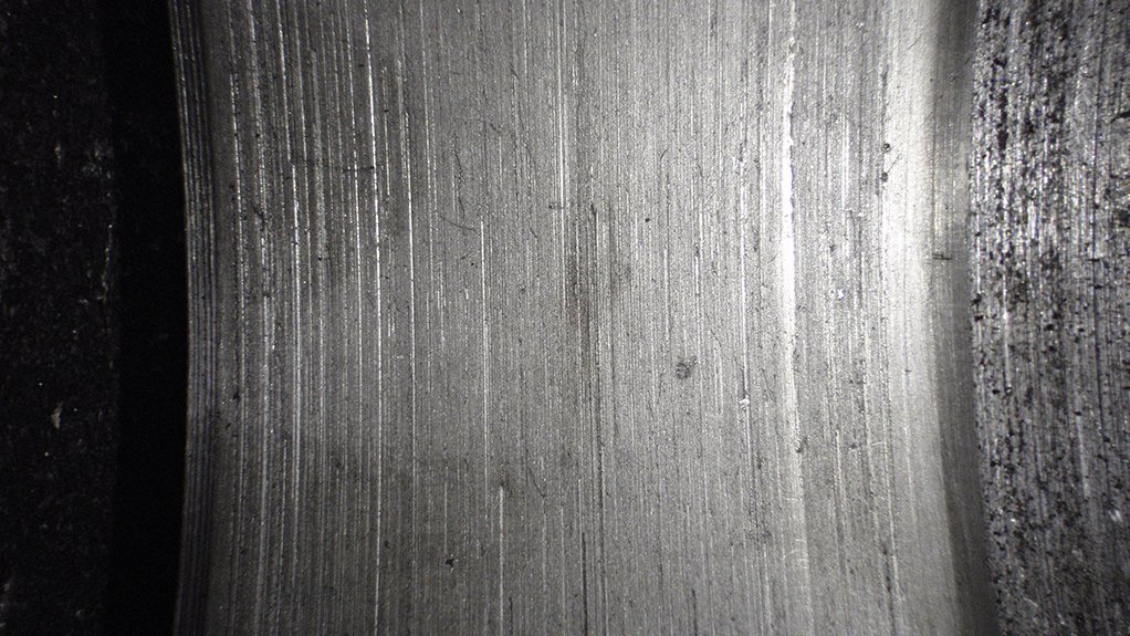 A metal component that can be seen with deep grooves in it caused by frictional wear