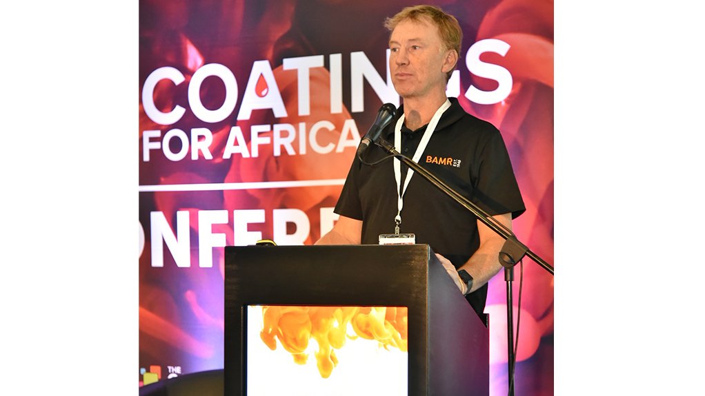 A man standing at a podium speaking on the topic of coatings and paint development at teh Coatings for Africa 2022 expo held in Sandton last month