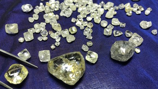 An image of rough diamonds on a blue table cloth