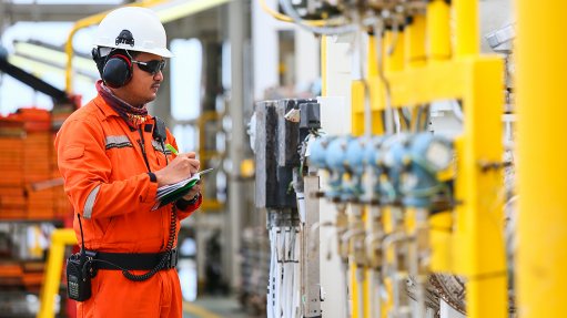 An image of an engineer at an oil and gas processing plant