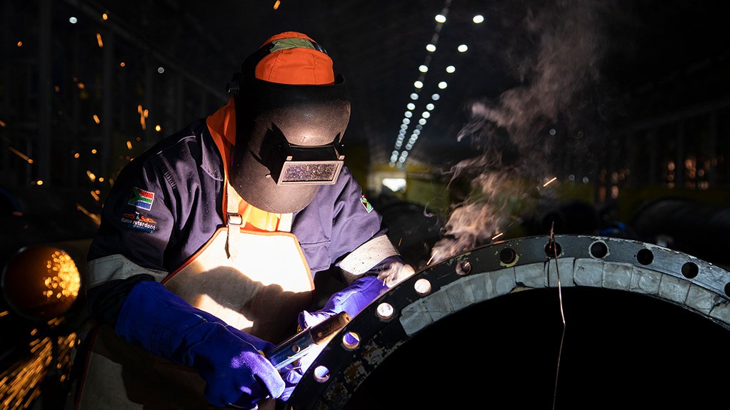 A welder at Hydra Arc's Middleburg premises is seen welding a large drum which will be used in the sugar industry