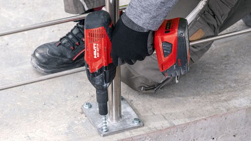 An image of somebody drilling a fastener into concrete using a Hilti power tool