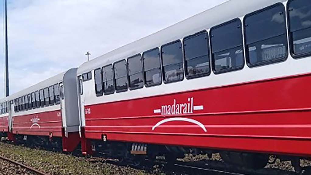 An image depicting a red Madarail train