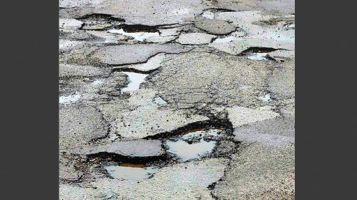 A photo of a potholed road