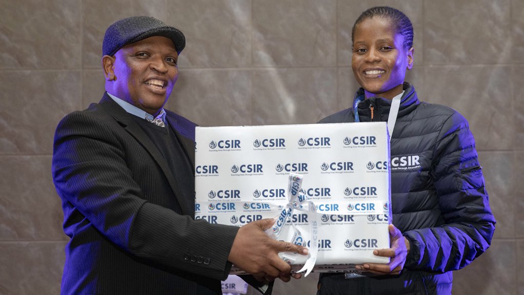 CSIR strategic partnership manager Dr Ndumiso Cingo hands a prize to emerging researcher Vivey Phasha