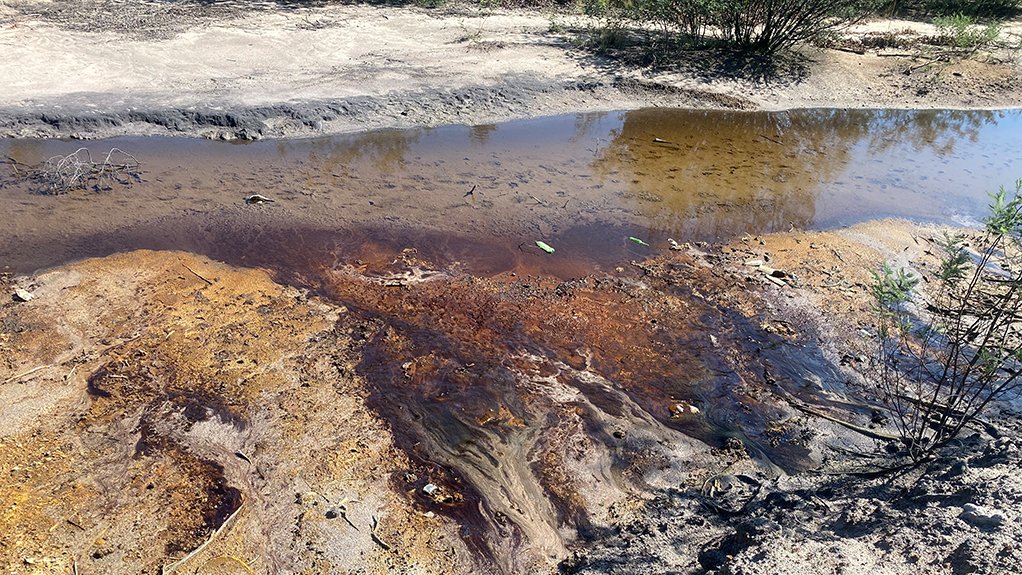 A river being affected by mine water seepage with brown and orange tinges