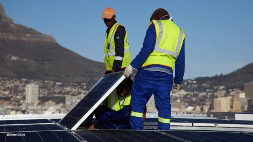 Workers installing rooftop solar