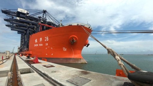 A large shipping vessel with gantry cranes and materials handling equipment is the first vessel to dock at the new Lekki port in Nigeria