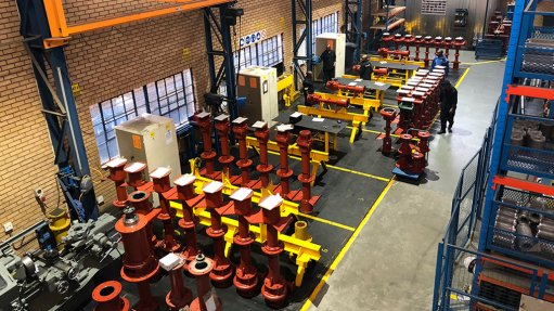 An aerial view of a factory floor with a range of vertical spindle pumps lined up ready for export