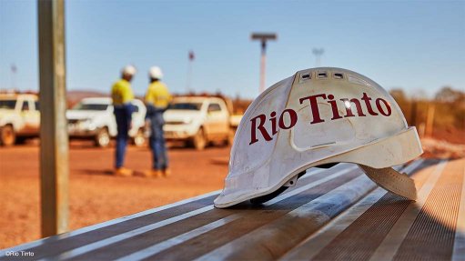 Image shows a Rio Tinto branded hard hat on a bench