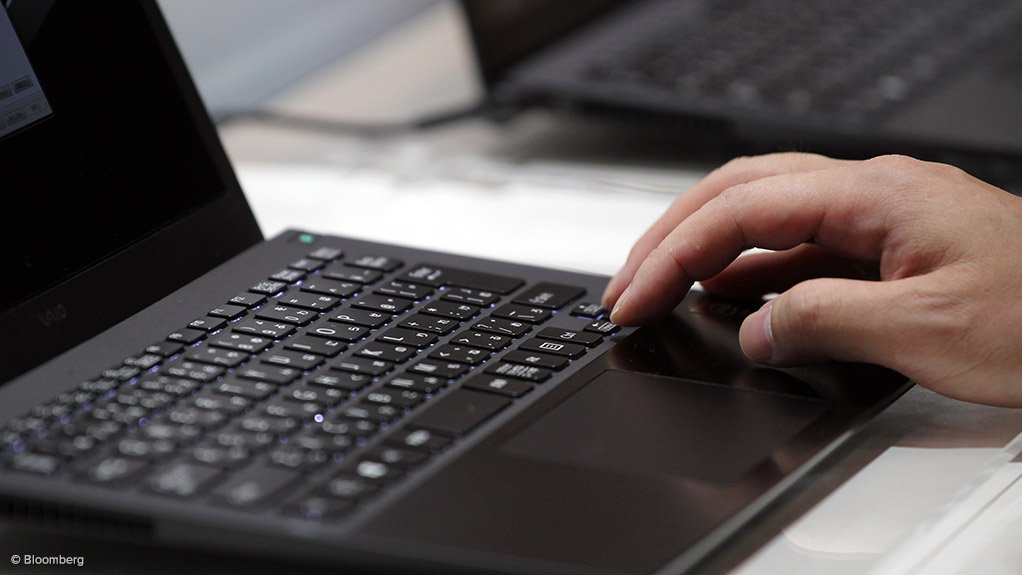 Photo of a person working on a laptop