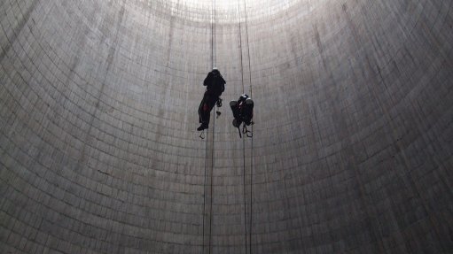 An image depicting two people using rope access