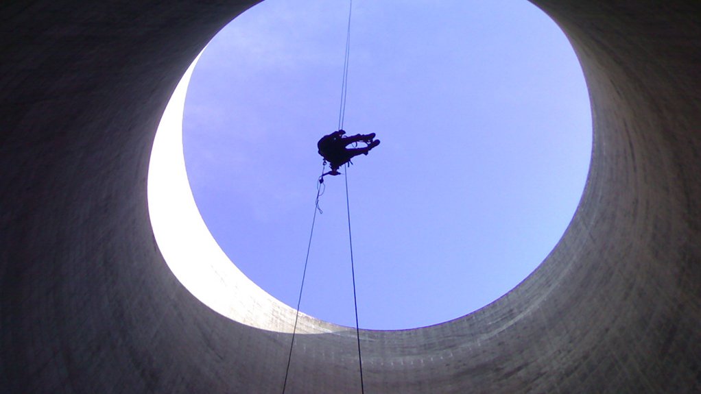 An image depicting someone suspended in the air using rope access