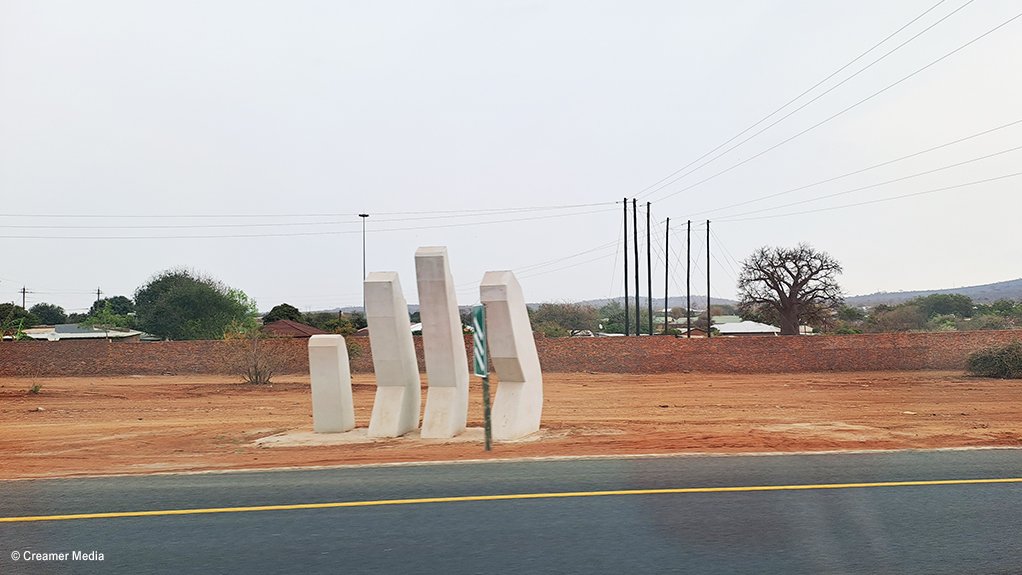 An image of a partial hand emerging from the ground alongside the Musina Ring Road project 