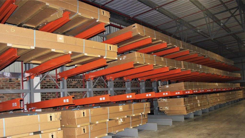 Metal brackets and beams affixedt a wall used as shelving in an automotove supplier warehouse