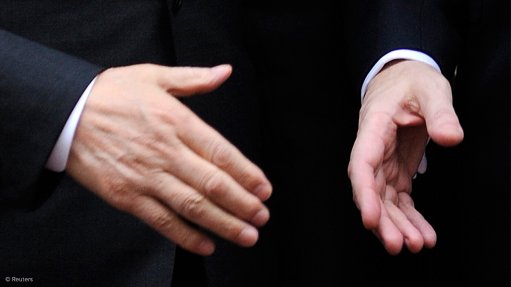 Image shows a hand shake