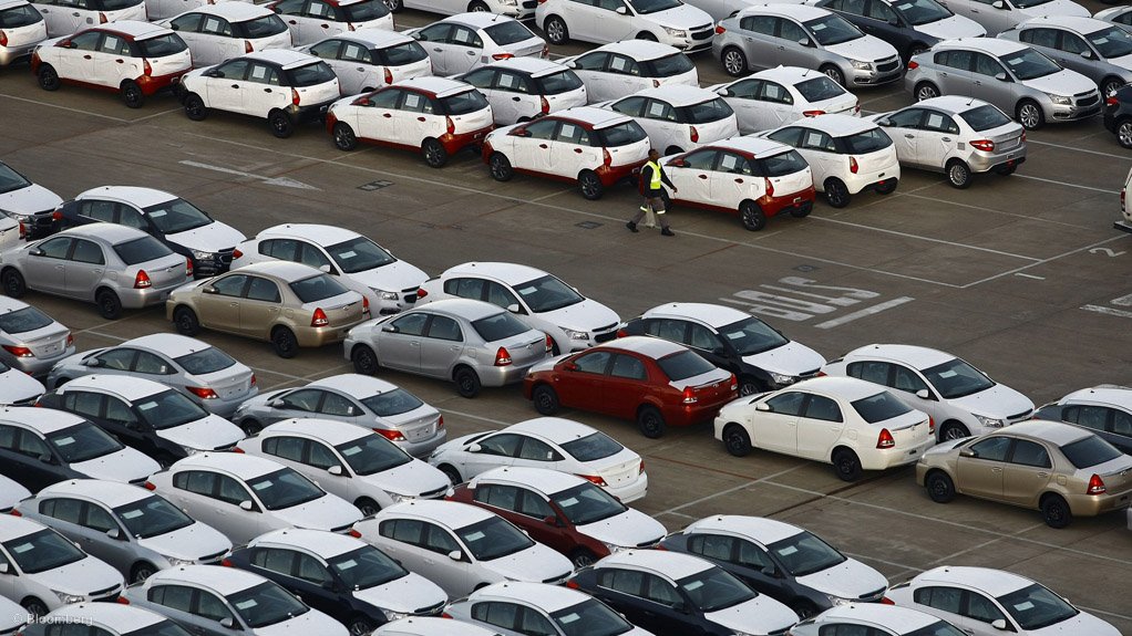 A photo of vehicles parked at a port for export