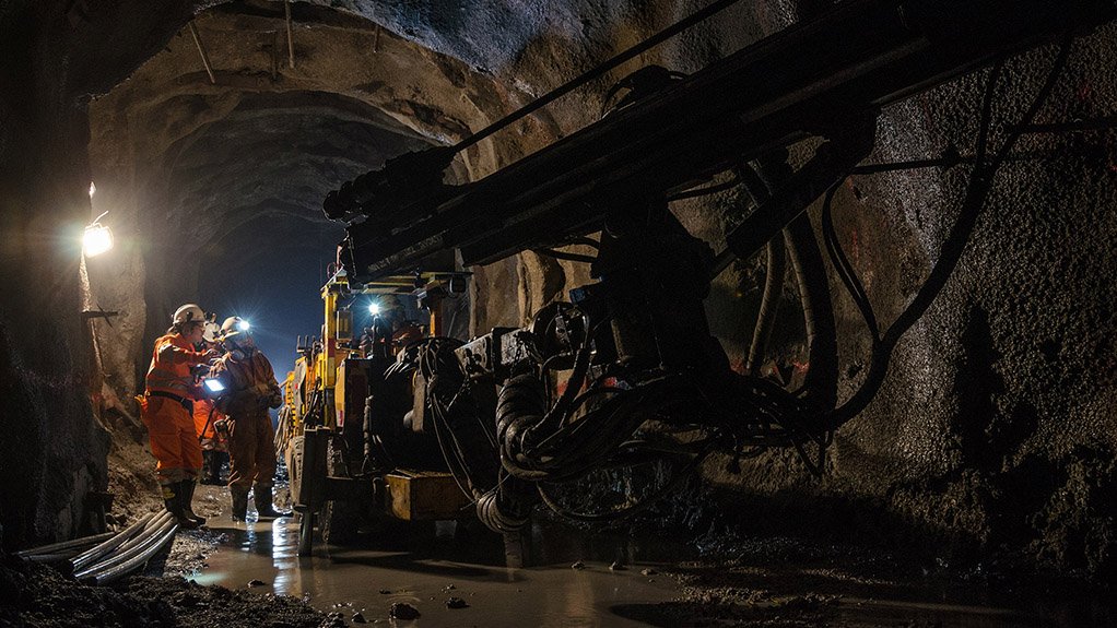 An image of a machinist working on underground mine equipment 