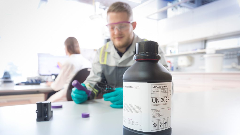 Evonik INFINAM powder in foreground and 3D printing in background