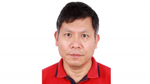 An image depicting a portrait of a man, Alan Zhao, wearing a red shirt