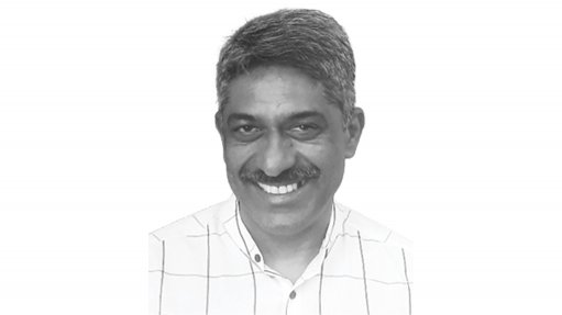 A monochromatic image depicting a smiling man, Bazil Govender