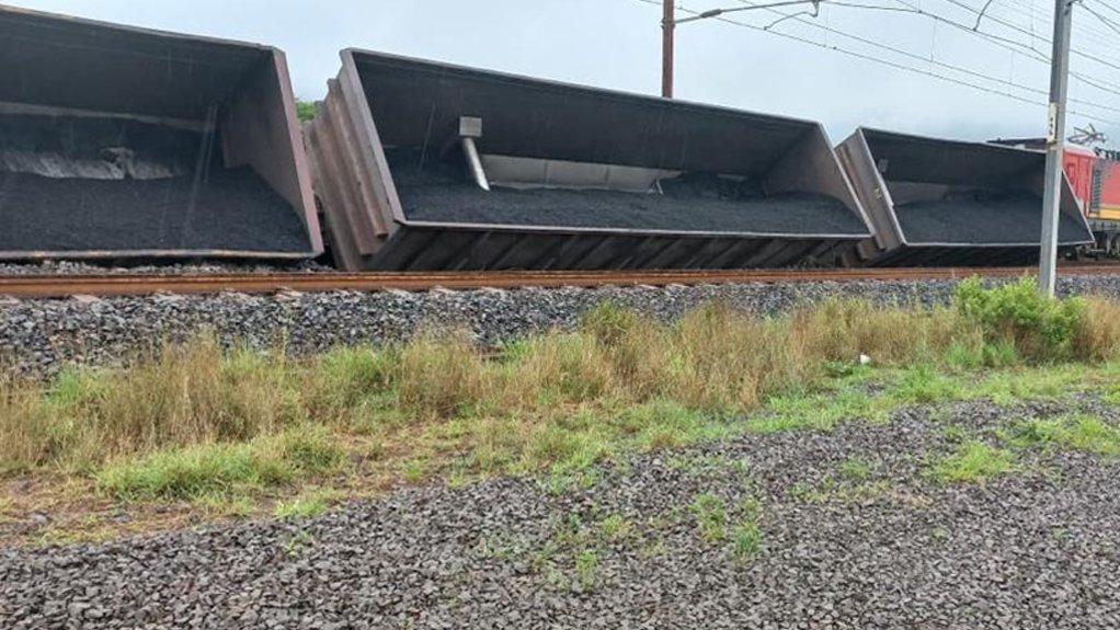 An image of a derailed coal train