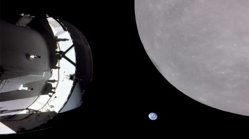 Screen shot of a video recorded on Monday by a camera mounted on one of Artemis I’s solar panels, showing the spacecraft itself, a distant Earth, and the far side of the Moon.   