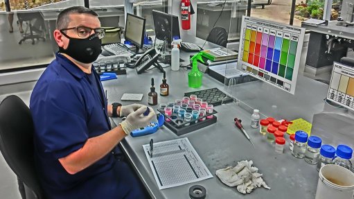 An image depicting a man, Shane Goslin, testing coolant samples 