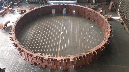 An image depicting a copper furnace being constructed