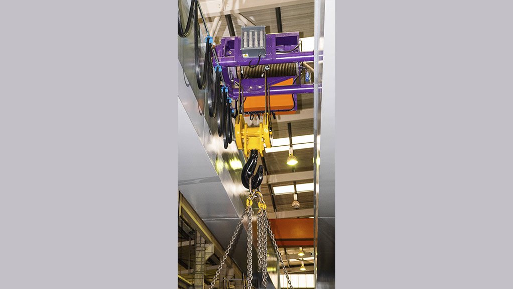 The underside of the crab-mounted hoist, finished in MMC Amethyst.
The container handler has been replaced with the optional lifting
 	              hook for load testing at Condra’s factory
