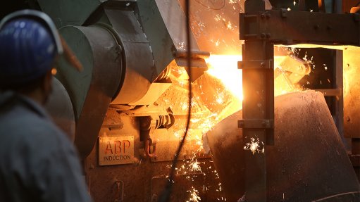 An ABP Induction services furnace in operation with man in PE near molten metal