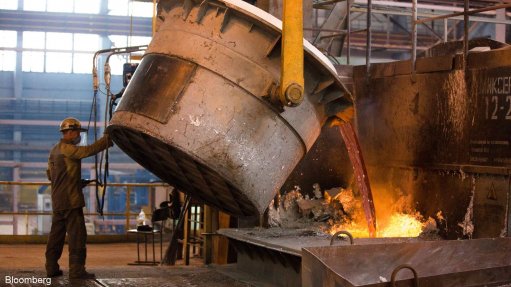 An image of a worker pouring aluminium at a smelter in Russia